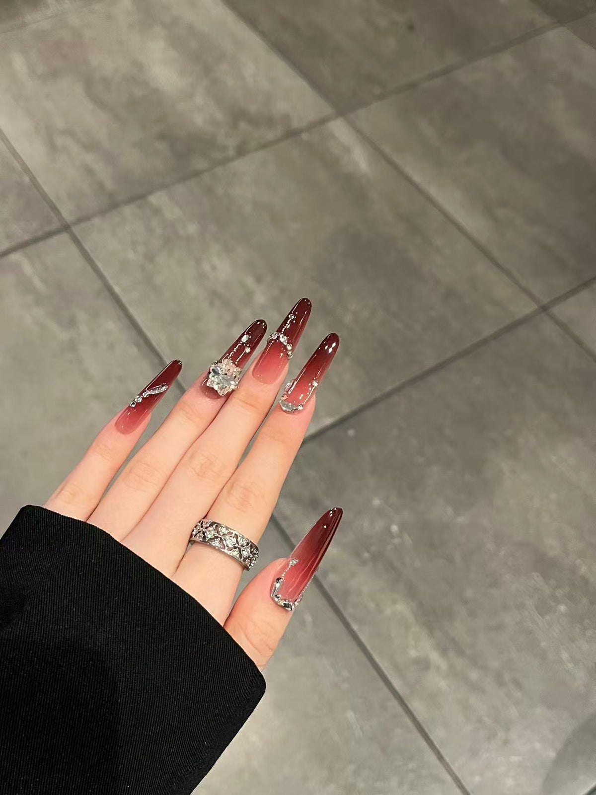 Close up of Crimson Muse nails showing the rich pigment and high-gloss gel finish.