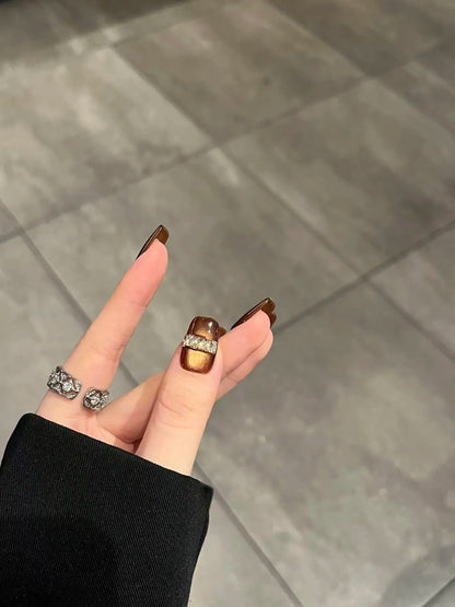 Amber Cat Eye - Close-up on hand.