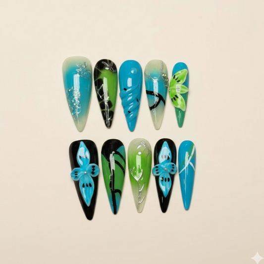 Island Fever - Teal and blue nails with hand-painted tropical leaves.